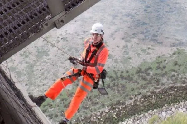 A man abseiling off a bridge 